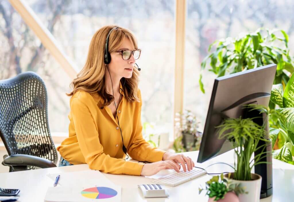 business woman with headset on computer