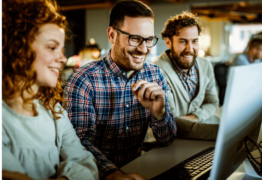 group of people sitting around a computer